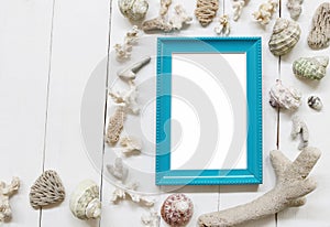 Blue Wooden photo frame on a white wood floor and have Shells and coral reefs