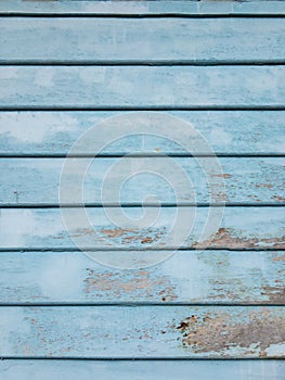 Blue wooden wall with color peeling