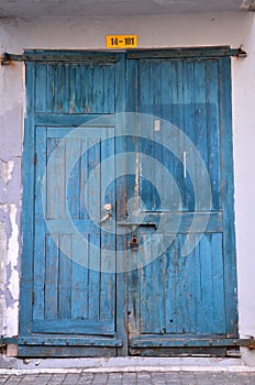 Blue wooden weathered door with padlock