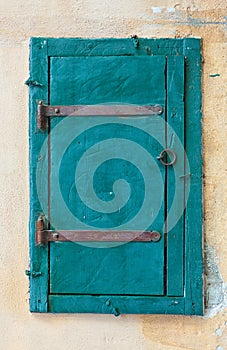 Blue wooden window shutters of a old mediterranean house