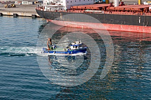 Blue Work Boat Past Tanker
