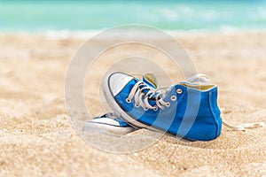 Blue Worn sneakers on beach sand