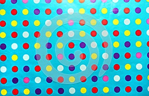 Blue wrapping paper with multicolored spots.