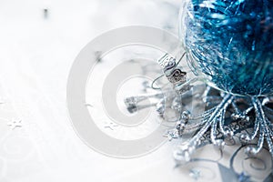 Blue xmas ornaments on bright holiday background