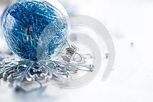 Blue xmas ornaments on bright holiday background