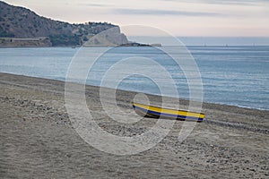 Blue and Yellow boat in a Mediterranean beach of Ionian Sea - Bova Marina, Calabria, Italy