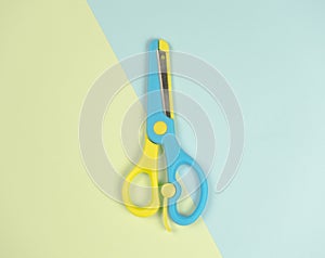 Blue and yellow colourful scissors on on blue and green background. beautiful colourful picture concept The same as the difference