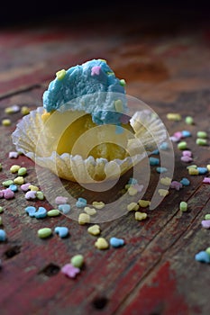 Blue and Yellow cupcakes with spring sprinkles with bite taken out