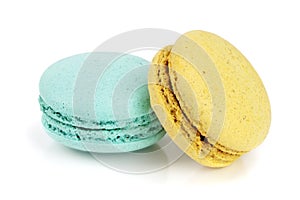 Blue and yellow macaroon isolated on white background closeup