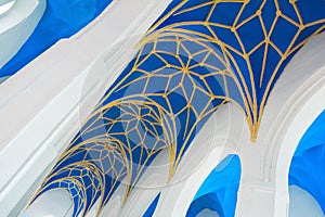 Blue and yellow ornamental church ceiling (nave) and white arches