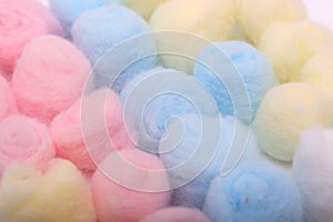 Blue, yellow and pink hygienic cotton balls in row