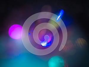 Blue, yellow and purple bokeh. Perfect abstract overlay footage. Trendy neon colors festive sparkling defocused lights