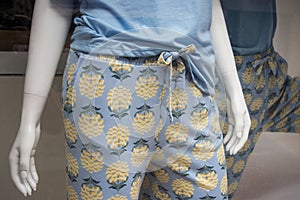 blue and yellow pyjama on mannequin in a fashion store showroom