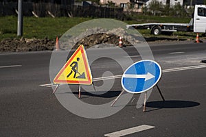 Blue and yellow-red safety signs warning about road works.The road is under construction or repair. Repair work in the