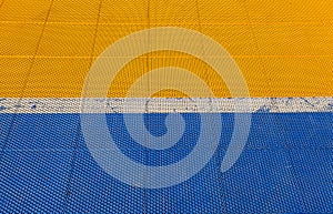 Blue and yellow rubber flooring on Futsal field background