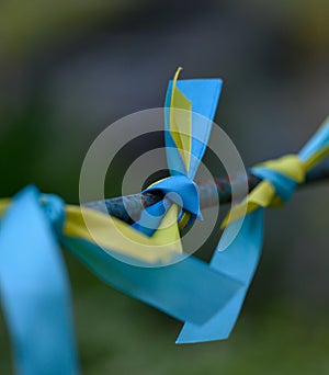 Blue and yellow silk ribbon tied on a metal tube. Ukrainian flag symbol, struggle for independence