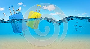 Blue and yellow suitcases drifting on the sea. Summer travel concept. Copy space