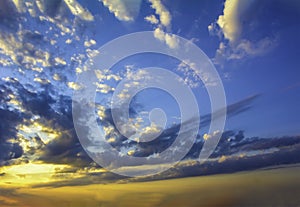 Blue yellow sunny sky and clouds background of dramatic cloudscape and skyscape with clouds in sunset