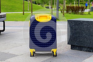Blue yellow travel suitcase with beautiful nature, relaxing vacation, holidays, weekends and travel. Suitcase near hotel, hostel,