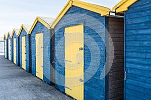 Blue and yellow wooden beach huts