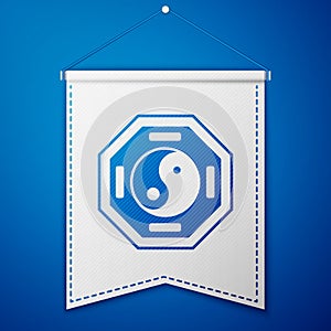 Blue Yin Yang symbol of harmony and balance icon isolated on blue background. White pennant template. Vector