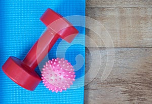 Blue yoga mat and Red dumbbell