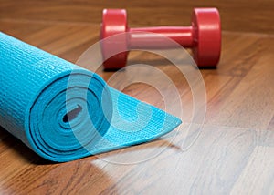 Blue yoga mat and Red dumbbell