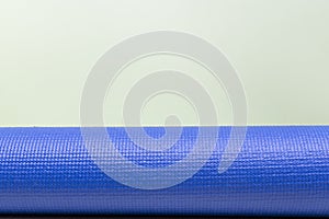 Blue yoga mat texture on green background