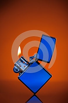 Blue zippo lighter on orange