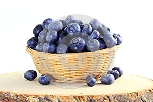 Blueberries in bamboo basket on white background