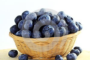 Blueberries in bamboo basket on white background