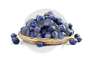 Blueberries in bamboo basket on white background