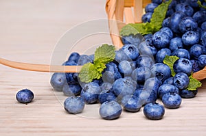 Blueberries in basket on wooden table