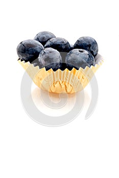 Blueberries in a gold foil cup