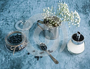 Blueberries in jar and flowers