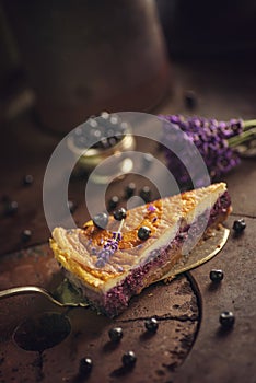 Blueberries and lavander cheesecake served on oven with berries and flowers, still life for patisserie, healthy cake