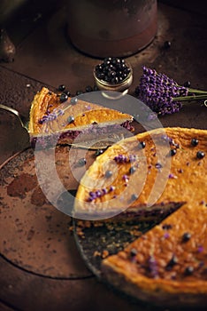 Blueberries and lavander cheesecake served on oven with berries and flowers, still life for patisserie, healthy cake