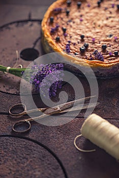 Blueberries and lavander cheesecake served on oven with berries and flowers, still life for patisserie, healthy cake