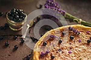 Blueberries and lavander cheesecake served on oven with berries and flowers, still life for patisserie, healthy cake