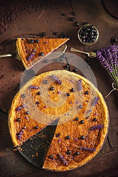 Blueberries and lavander cheesecake served on oven with berries and flowers, still life for patisserie, healthy cake