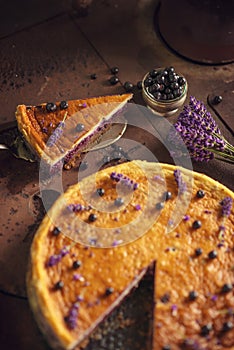 Blueberries and lavander cheesecake served on oven with berries and flowers, still life for patisserie, healthy cake