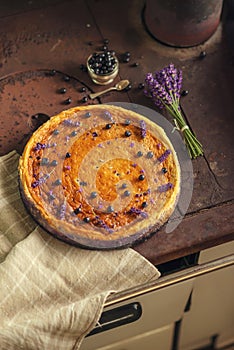 Blueberries and lavander cheesecake served on oven with berries and flowers, still life for patisserie, healthy cake