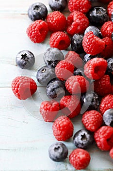 Blueberries and raspberries on wooden table