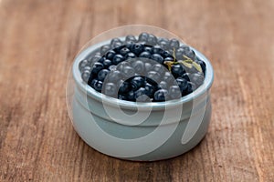 Blueberries on rustic rown wooden board background. Healthy eating