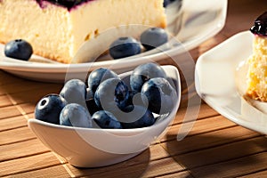 Blueberries served with cheesecak and a cap of coffee