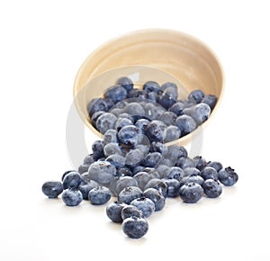 Blueberries spilling out of a bowl