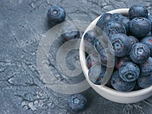 Blueberries in spoon on dark background