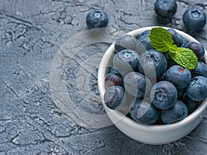 Blueberries in spoon on dark background