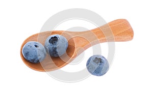 Blueberries on spoon isolated white background with clipping path without shadow