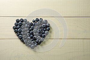 Blueberries summer berry on wooden table. Vitamin C, E, P, PP, B carotene flavonoids ascorbic acid. Organic fresh photo